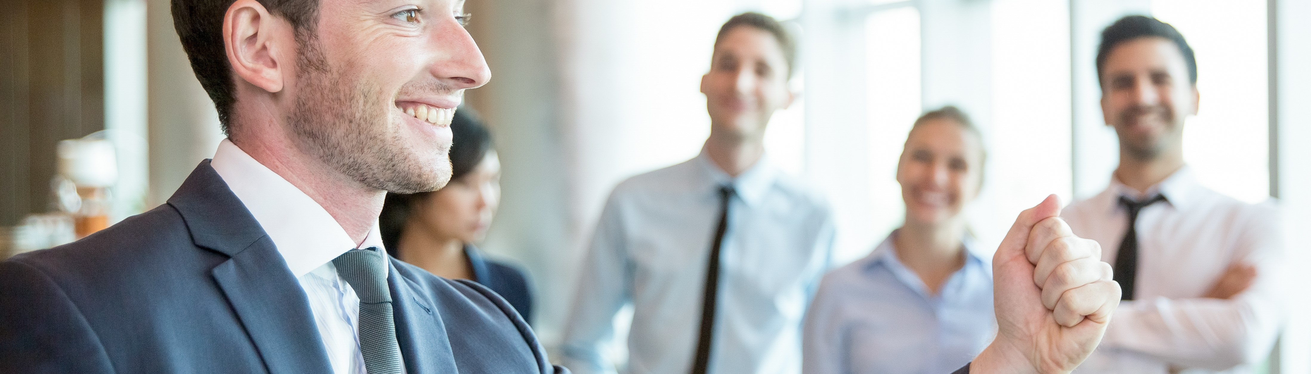 Cheerful leader motivating his business team